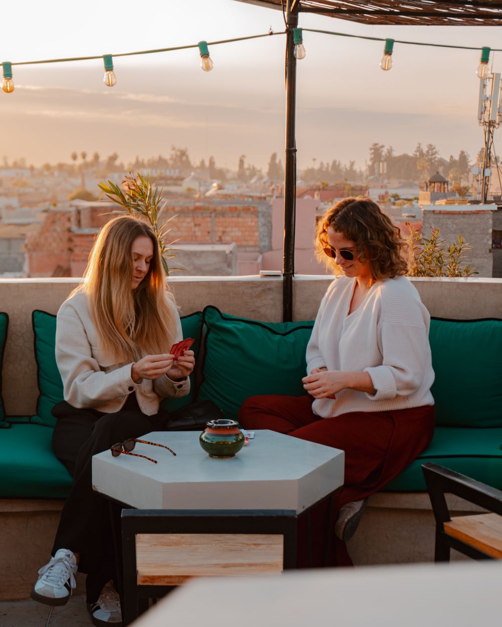 The rooftop terrace lit by lanterns at dusk