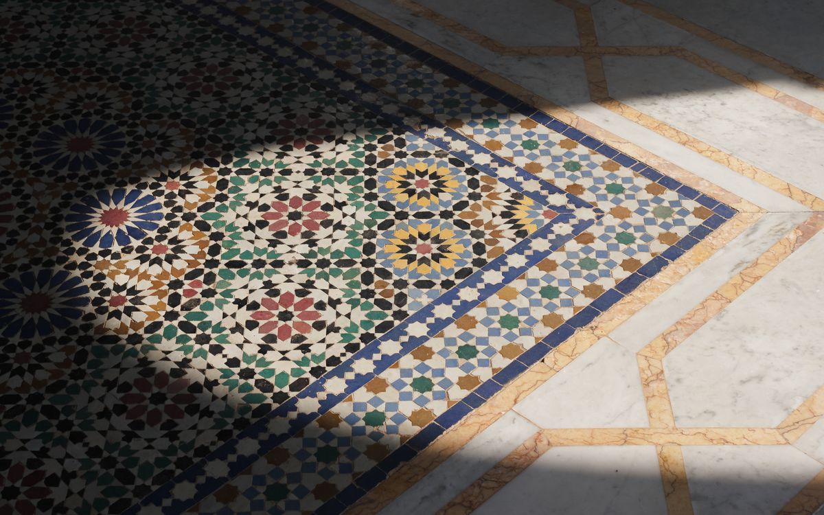 Close-up of hand-cut green and white zellige tiles