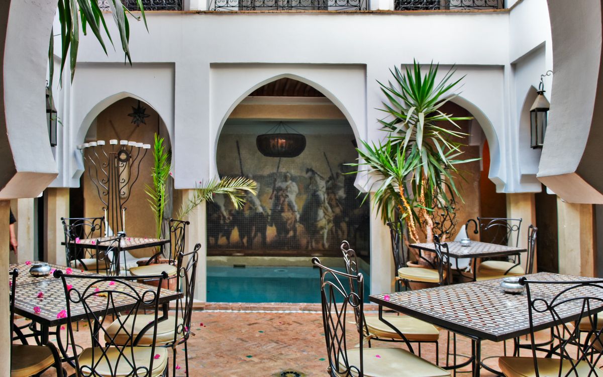 Breakfast of msemmen, honey and fresh orange juice in the courtyard