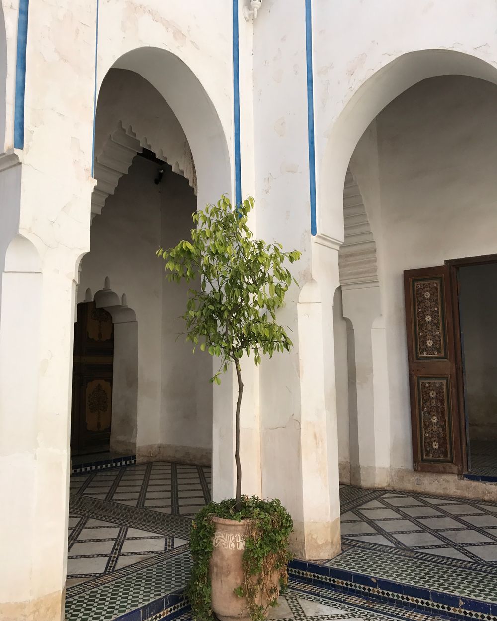 An arched doorway opening onto the tiled courtyard